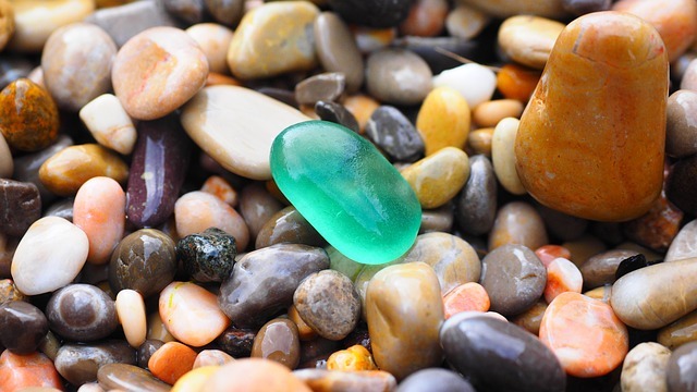 A close-up image of sea glass and pebbles.